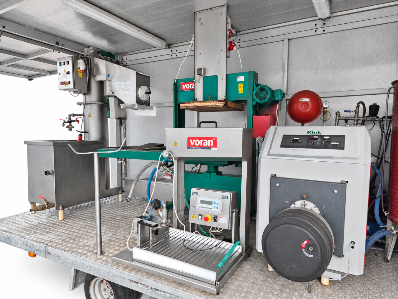 Pressing, pasteurizing and filling equipment inside the mobile trailer